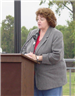 Woman talking at the podium during the dedication