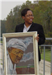 Keisha West holding a painting of her great uncle