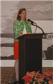Woman speaking at podium during dedication
